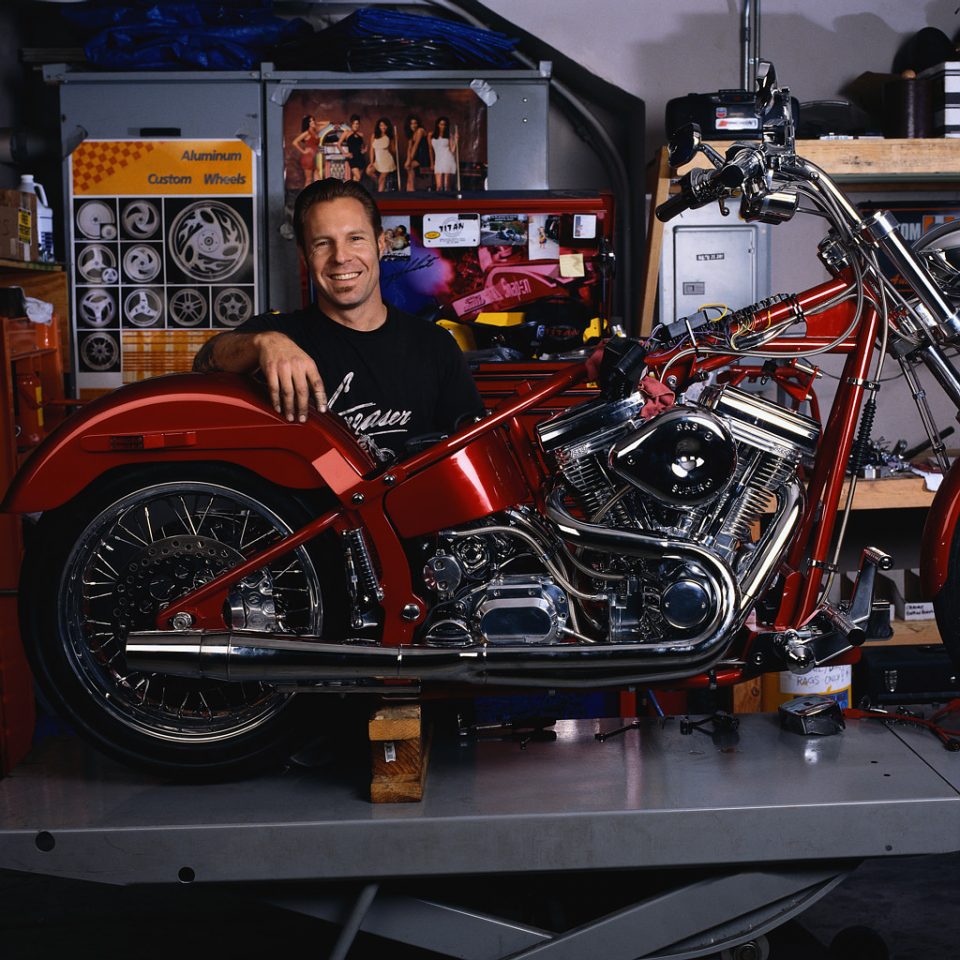 Mechanic with Motorcycle at Repair Shop
